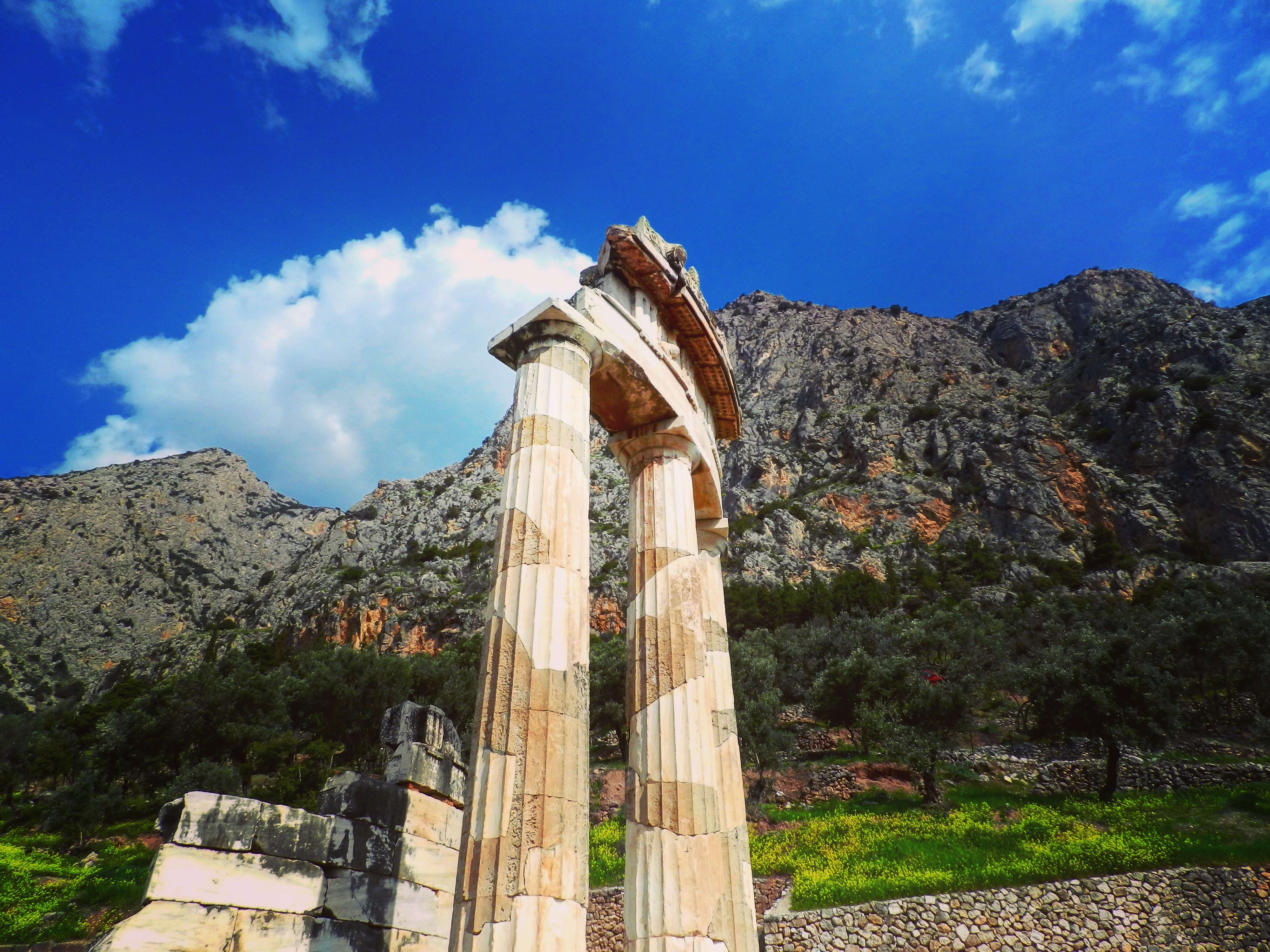 Ancient columns at Delphi with mountains behind