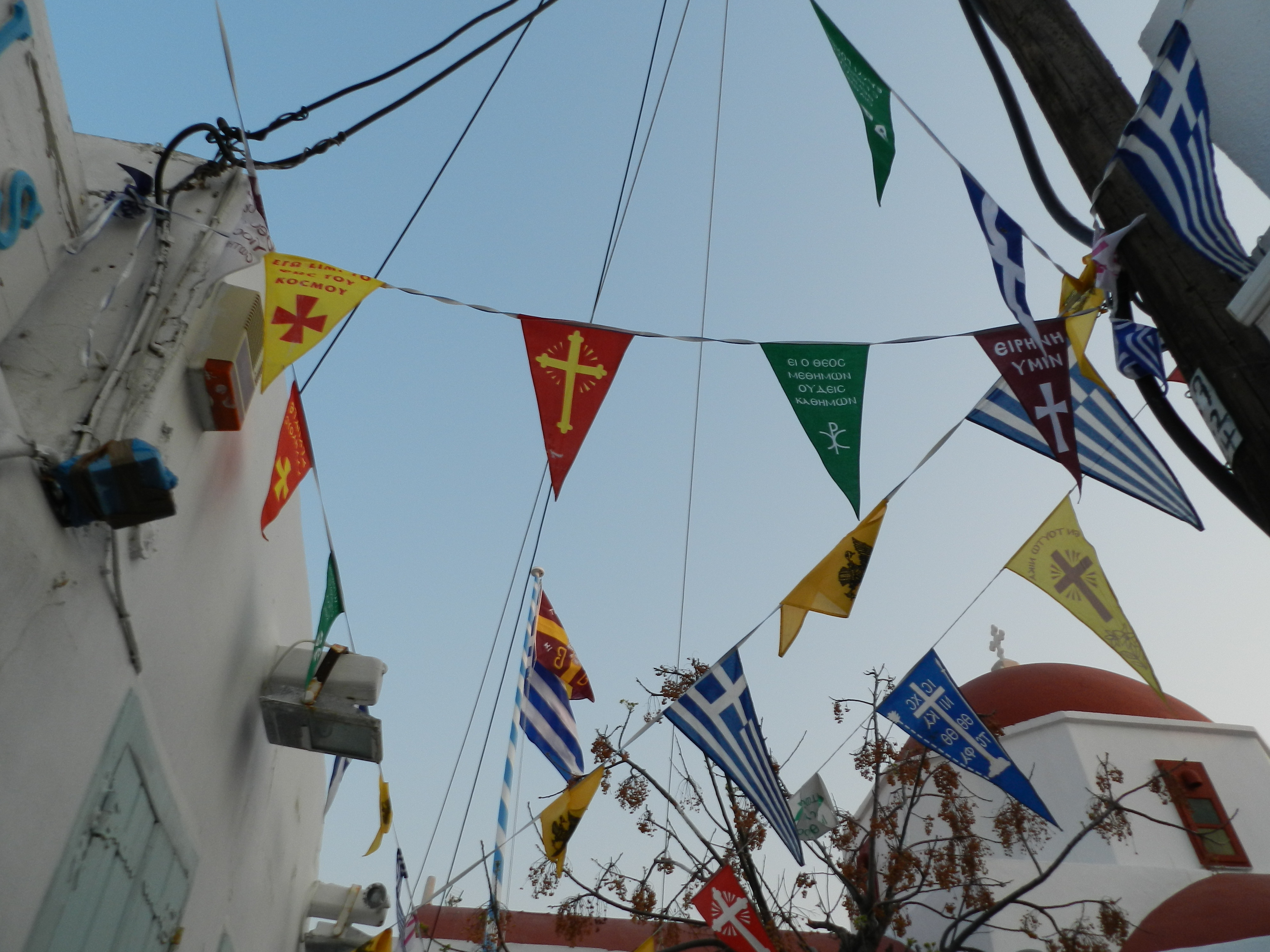 Colorful Greek Orthodox pennant flags strung above a street