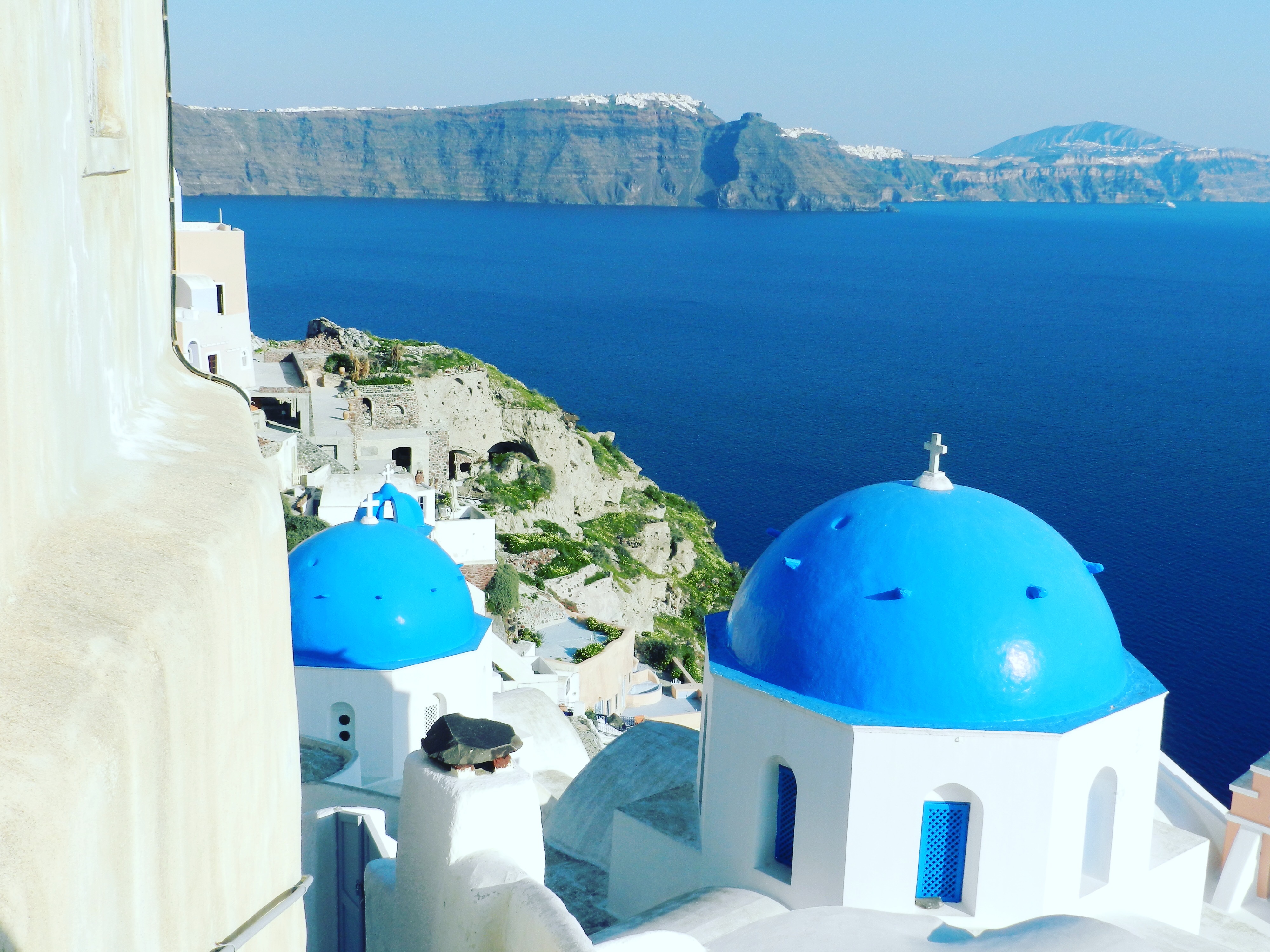 Santorini blue-domed churches overlooking the caldera