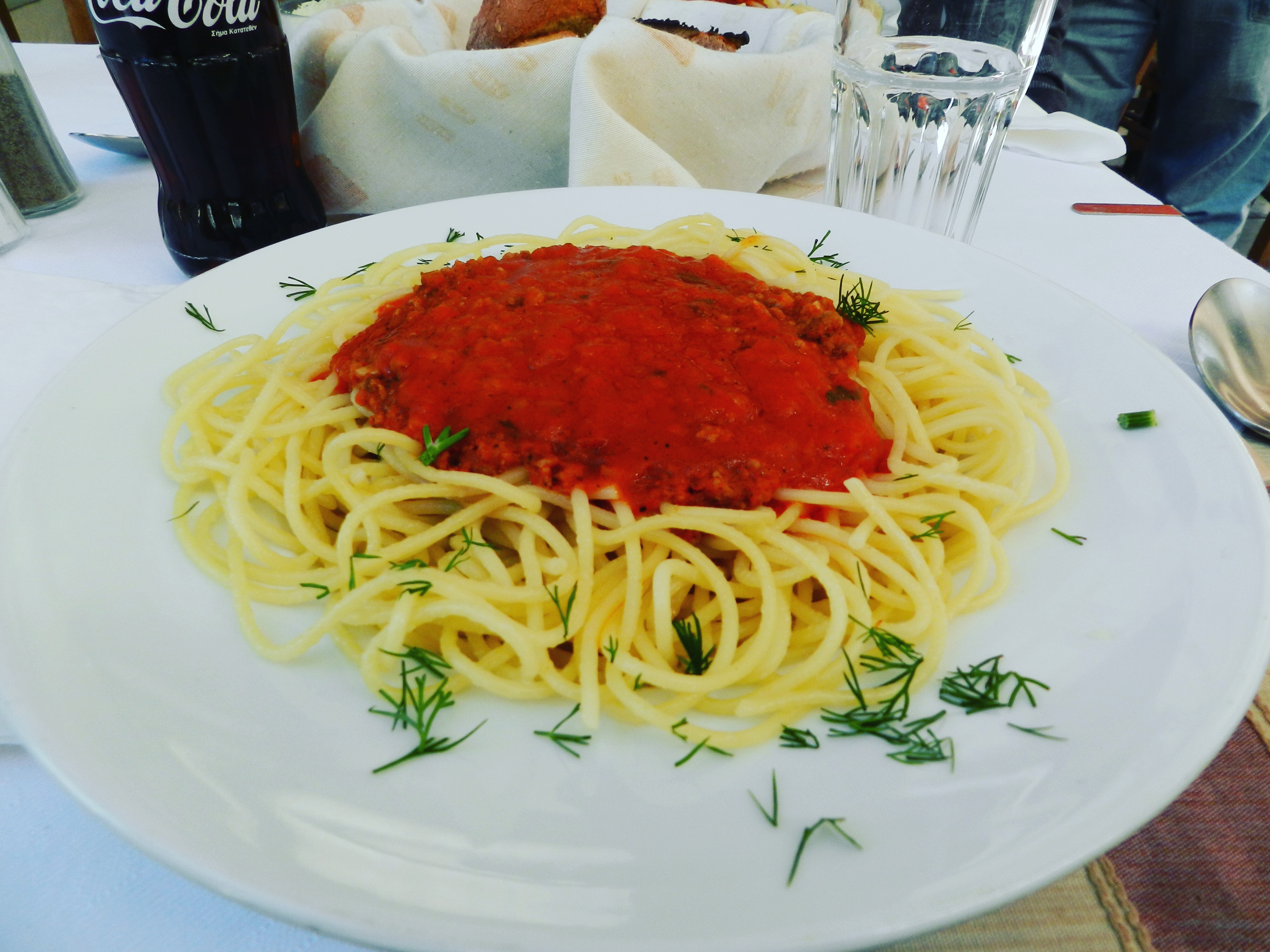 Plate of spaghetti with meat sauce at a restaurant table