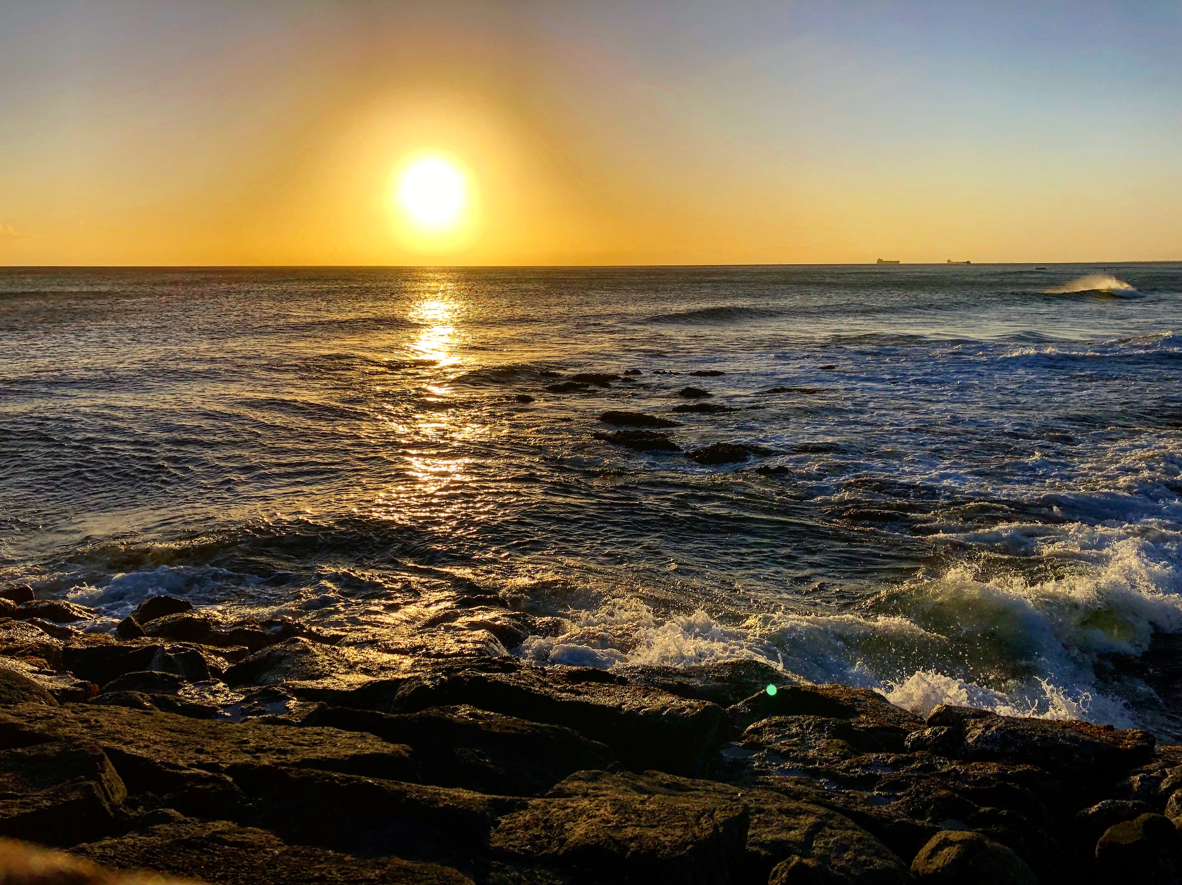 Sunrise over the ocean from a rocky shoreline